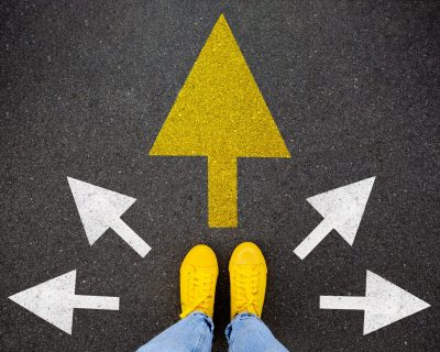 Feet walking away with directions arrow. Taking main decision for the future. Sneaker shoes top view road. Hipster woman standing on floor or pathway to success. Creative idea, future concept